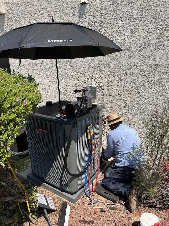 HVAC technician performing outdoor AC maintenance in Cartersville